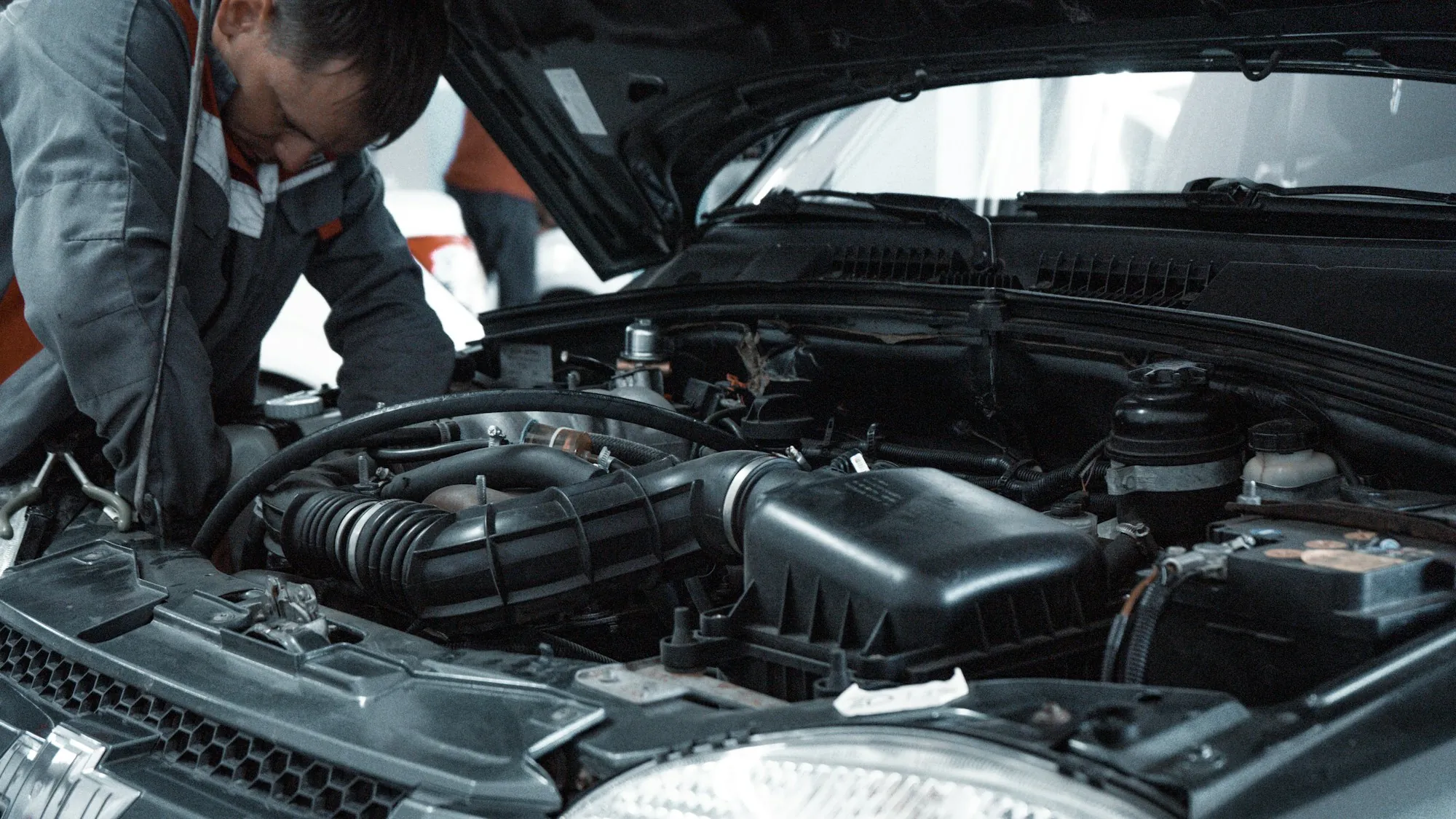 Two technicians studying an open engine bay together